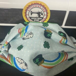 Pot of Gold Snoopy Face Mask - This face mask features Snoopy and a rainbow and pot of gold. Great for St. Patrick's Day. #StPatricksDay #PotofGold #Rainbow #Snoopy