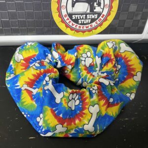 Tye-Dye Dog Bone Scrunchie is a Scrunchie with a Tye-Dye theme and dog bones and paw prints on it.