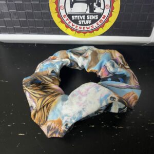 Cow Faces Scrunchie is a Scrunchie with the faces of different types of cows on it.