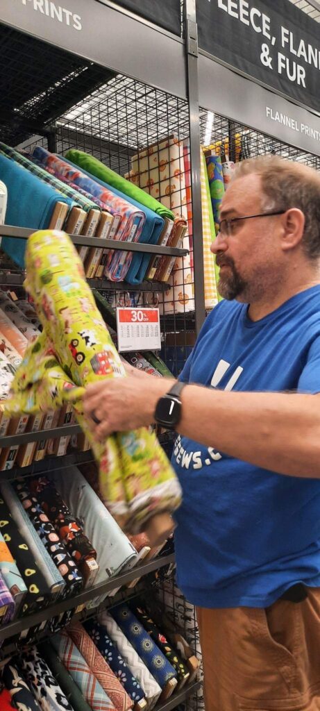 Steve looking at Fabric for projects at JoAnn’s (West Knoxville, TN) ​ Photo Credit: Heather Patterson  - fabric obsession 